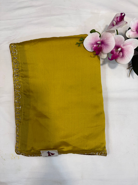 Yellow fabric pouch with a brand label on a white background with purple flowers.